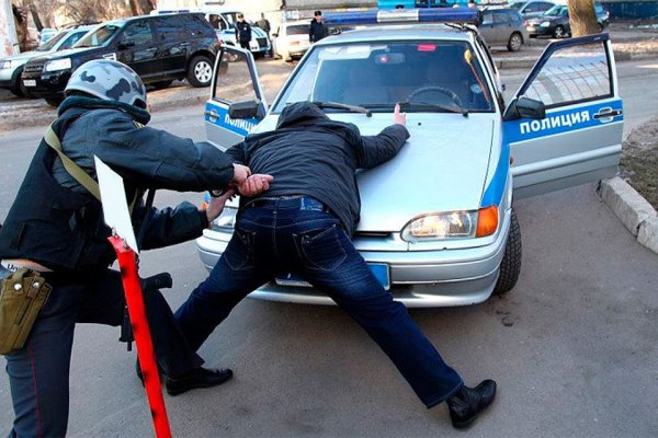 Полицейский задерживает преступника