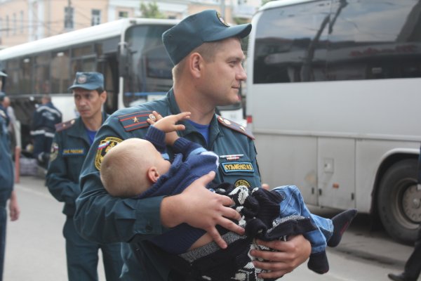 Полицейский с ребенком на руках